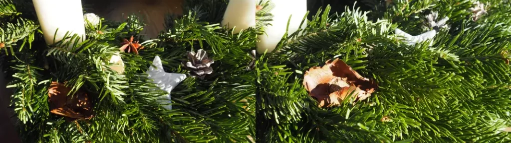 Eine Nahaufnahme vom Adventskranz mit Tannenzapfen, Sternen aus selbstgemachtem Fimo und Blumen aus Baumrinde